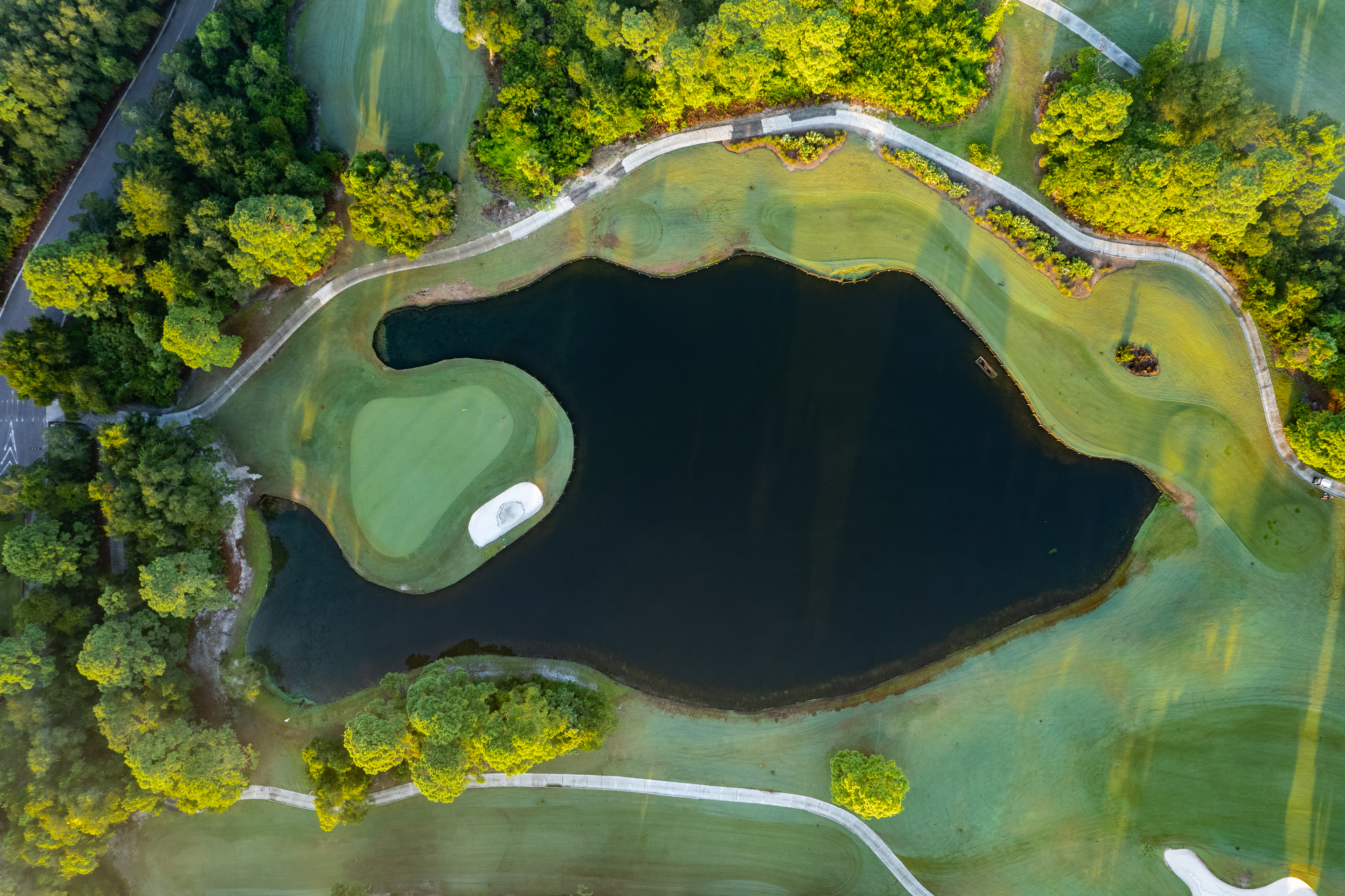 Birds eye view of pond on golf course